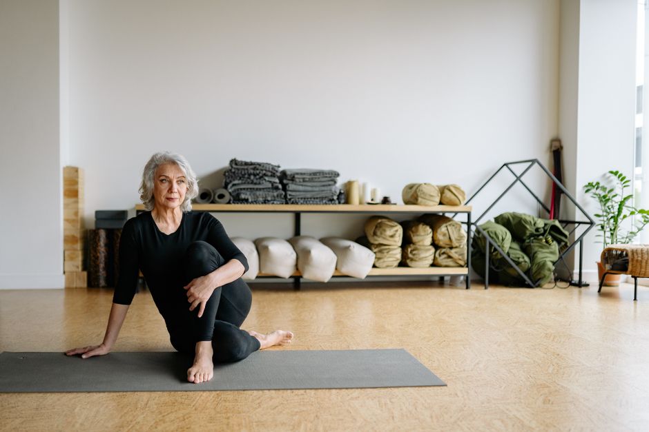 A student resting in a supported yin pose